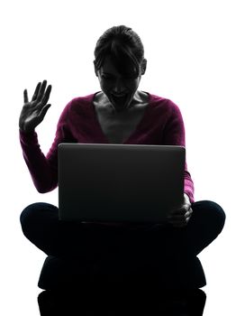 one caucasian woman saluting computing laptop computer  in silhouette studio isolated on white background
