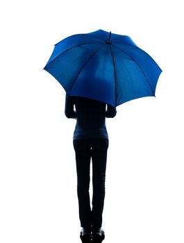 one caucasian woman rear view  holding umbrella  in silhouette studio isolated on white background