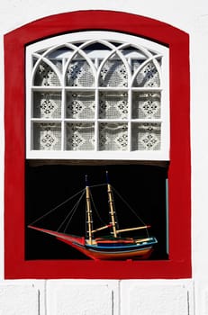 boat model at a window of the beautiful portuguese colonial typical town of parati in rio de janeiro state brazil