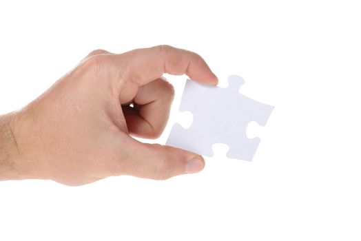 Hand hold a piece of jigsaw puzzle isolated on white