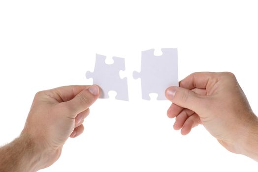 Hands with two puzzles. Isolated on white background 