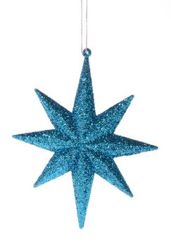 Blue glittering star shaped Christmas ornament isolated on pure white background 