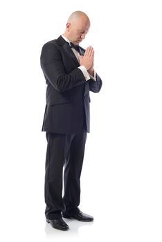 one caucasian  man in a tuxedo thinking praying portrait silhouette in studio isolated on white background