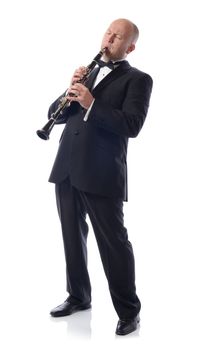 man in suit playing the clarinet isolated on white