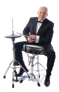 man in tuxedo playing drums isolated on white