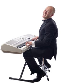 man in tuxedo playing keyboard