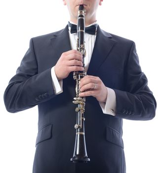 man in suit playing the clarinet isolated on white