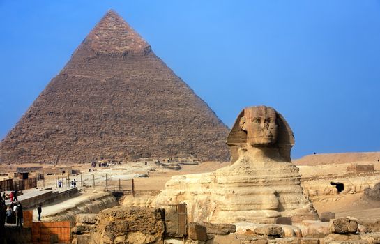 view of the sphynx with the pyramids of gizah near cairo in egypt