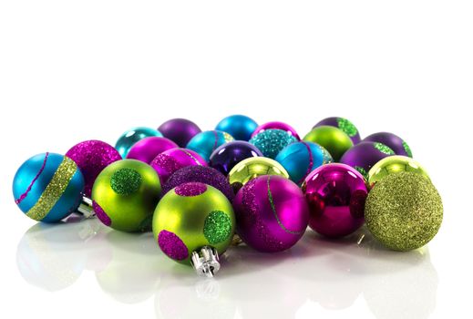 christmas balls in blue green pink on white background