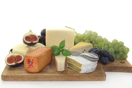 different types of cheese on a wooden board