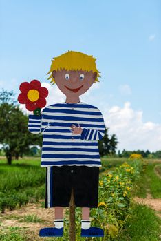 Handcrafted boy symbol promoting a field to pick your own flowers