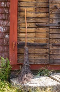 Broom at the entrance of a rustic Scandinavian house.