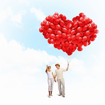 Image of young happy family with bunch of balloons