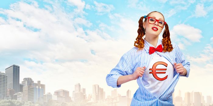 Young woman acting like super hero with euro sign on chest