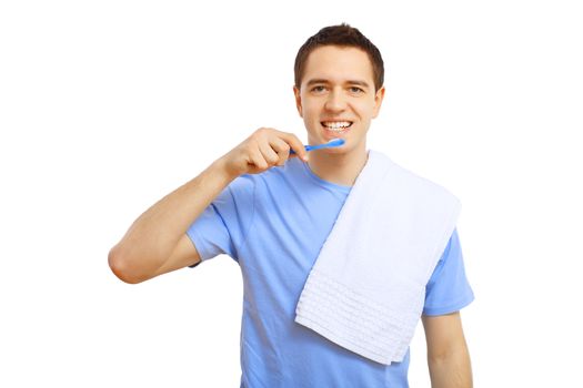 Young man in blue shirt brushing his teeth