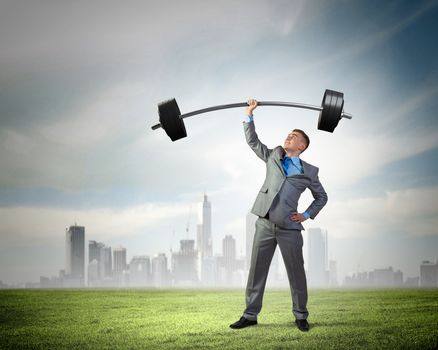Image of strong businessman lifting barbell above head with one hand