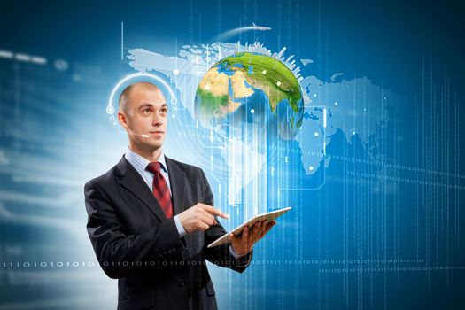 Image of businessman with tablet pc. Elements of this image are furnished by NASA