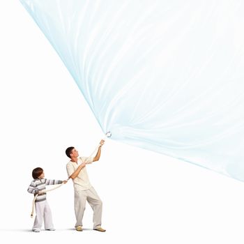 Young happy family pulling blank banner. Place for text