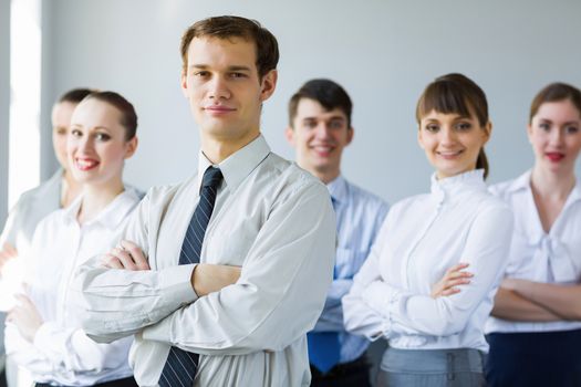 Young business people standing with arms crossed on chest