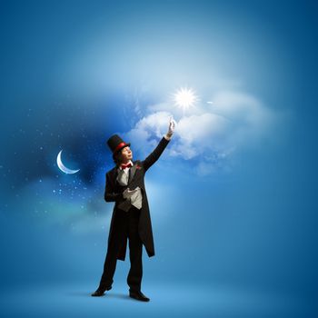 Image of man magician against color background