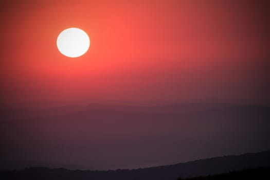 beautiful red autumn sunset over the hills