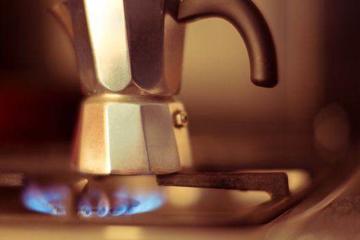 Italian coffee maker on stove, artistic photo with shallow depth of field 