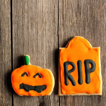 Halloween homemade gingerbread cookies over wooden table