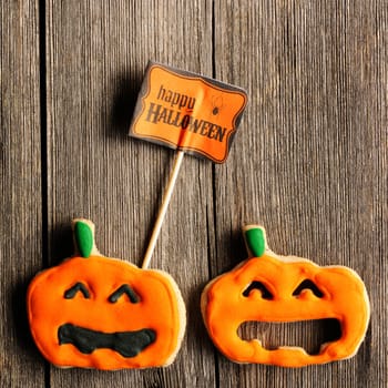 Halloween homemade gingerbread cookies over wooden table