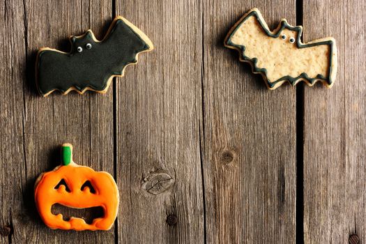 Halloween homemade gingerbread cookies over wooden table