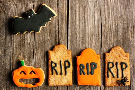 Halloween homemade gingerbread cookies over wooden table