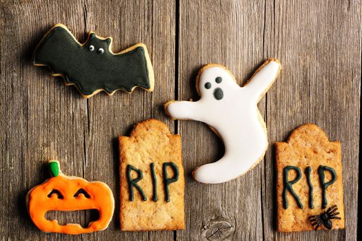 Halloween homemade gingerbread cookies over wooden table