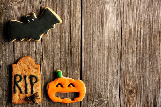 Halloween homemade gingerbread cookies over wooden table