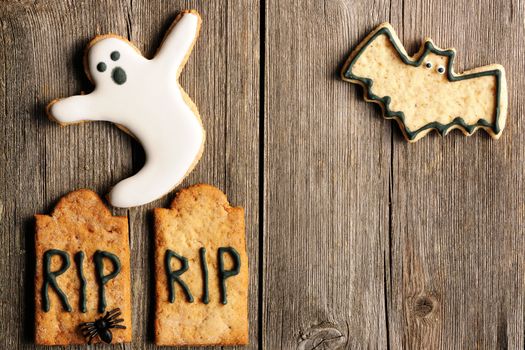 Halloween homemade gingerbread cookies over wooden table