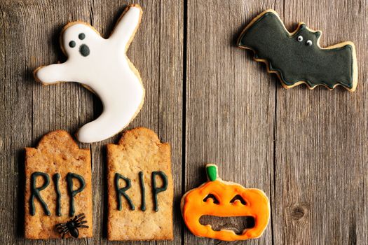 Halloween homemade gingerbread cookies over wooden table