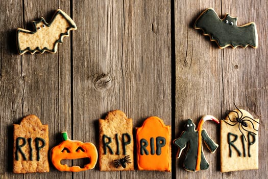 Halloween homemade gingerbread cookies over wooden table