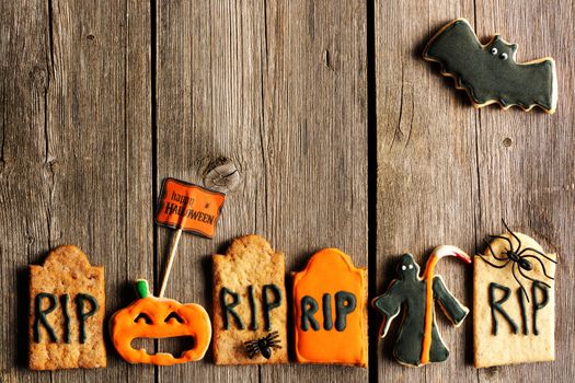 Halloween homemade gingerbread cookies over wooden table