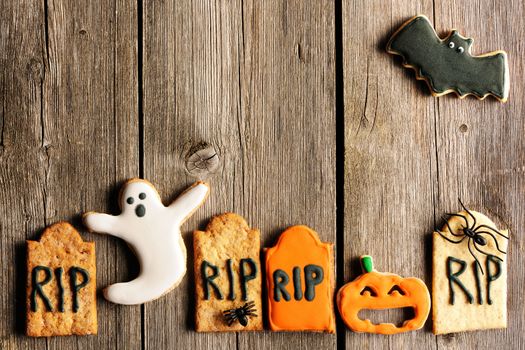 Halloween homemade gingerbread cookies over wooden table