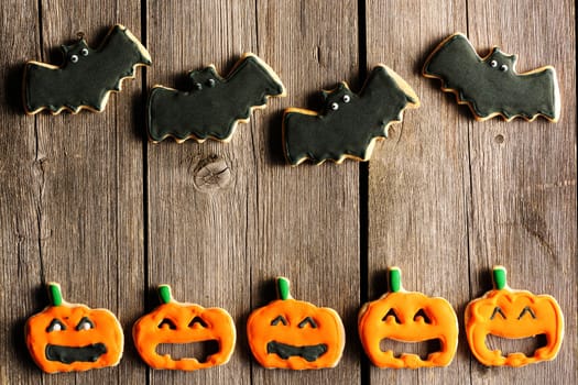 Halloween homemade gingerbread cookies over wooden table