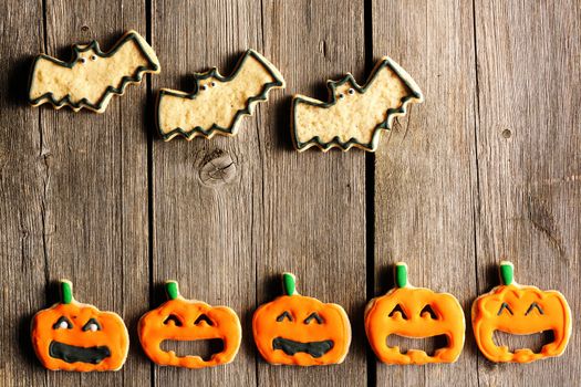 Halloween homemade gingerbread cookies over wooden table