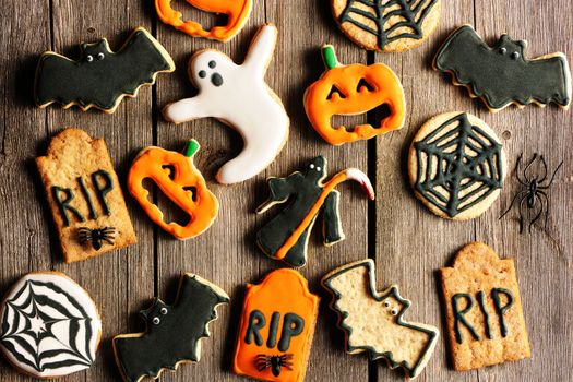 Halloween homemade gingerbread cookies over wooden table