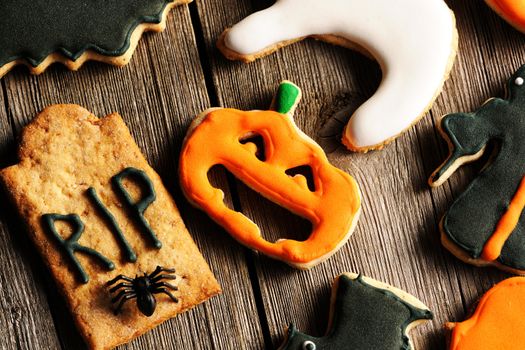 Halloween homemade gingerbread cookies over wooden table