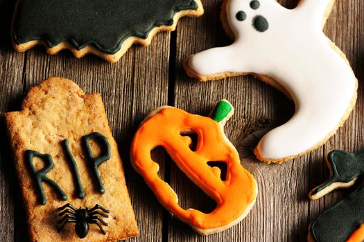 Halloween homemade gingerbread cookies over wooden table