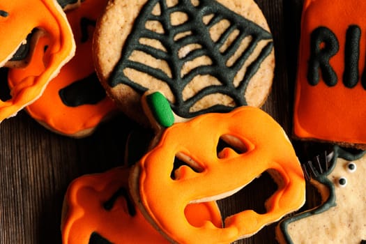 Halloween homemade gingerbread cookies over wooden table