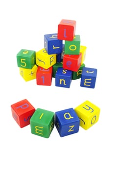 child's building blocks in primary colours on a white background. The word at the front spells 'play'