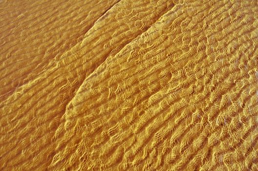 Transparent wave of the sea on the sandy beach