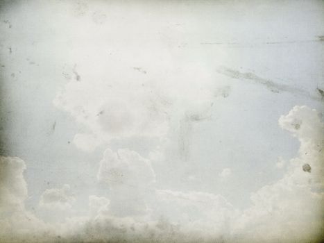 Fog and clouds on a vintage, textured paper background with a color gradient.