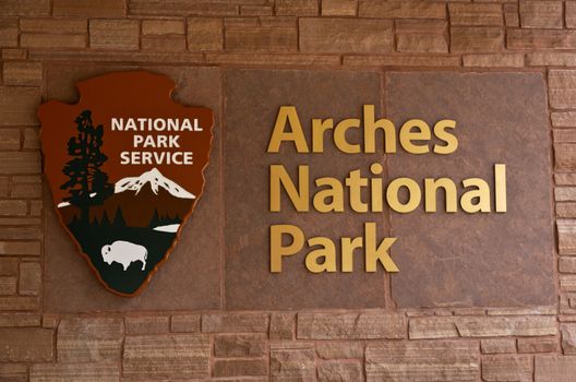 Sign for Arches National Park in Moab, Utah, USA, part of America's national park system, and an iconic, Southwestern desert tourism attraction; 