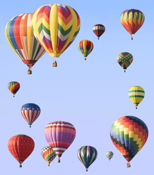 Hot-air balloons arranged around edge of frame allowing space for text in the center of blue sky
