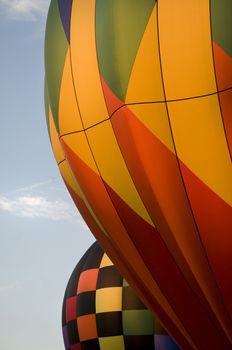 Close-up of the colorful envelops of two hot-air balloons