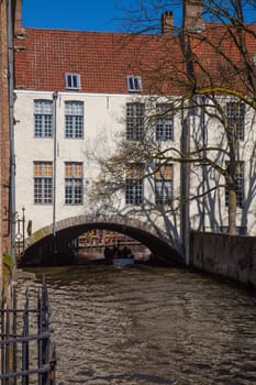 This house is buiilt over a canal. Tour boats take visitors through Bruges on these canals